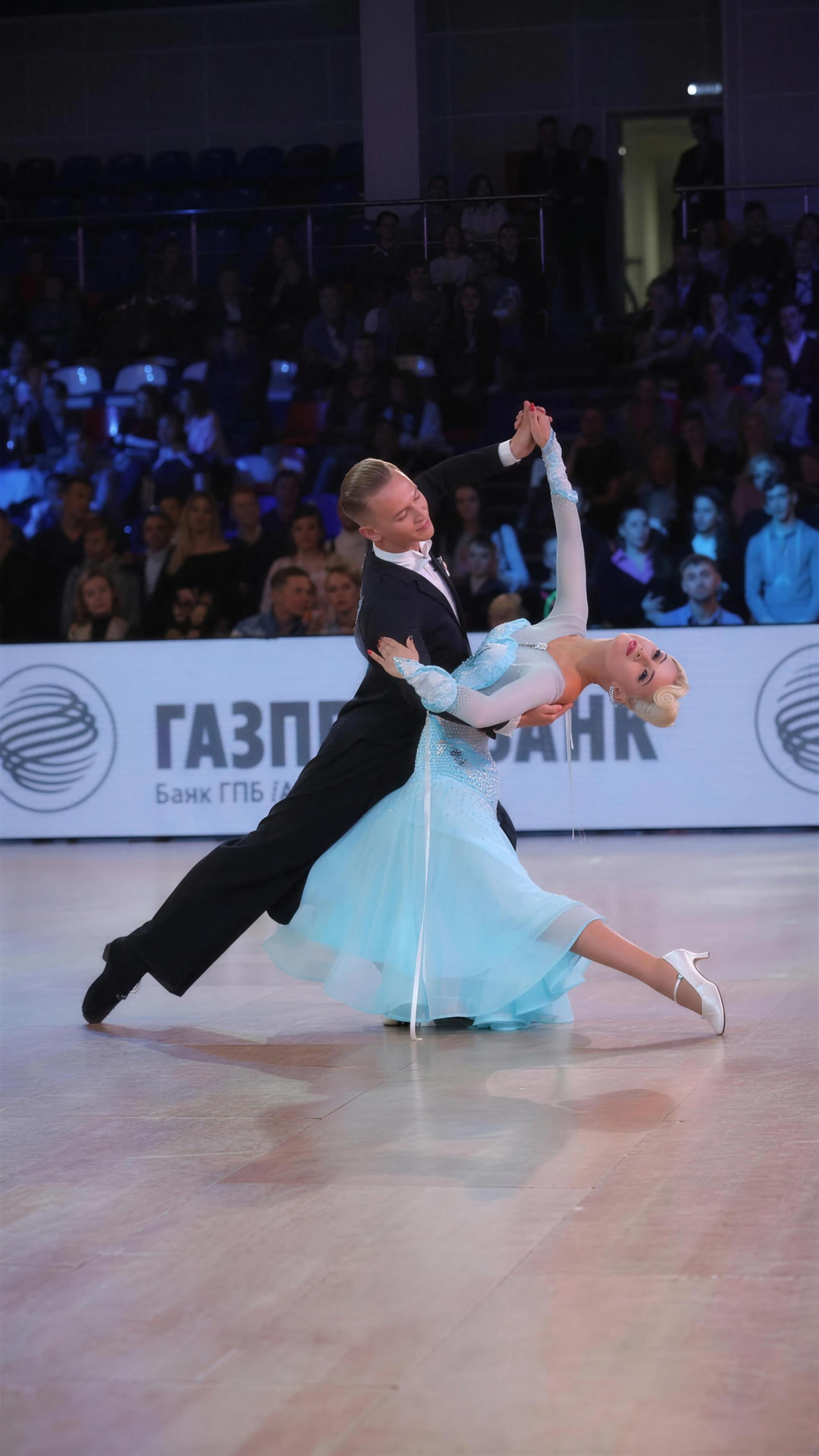 Ballroom couple dancing a Waltz throwaway oversway under a spotlight